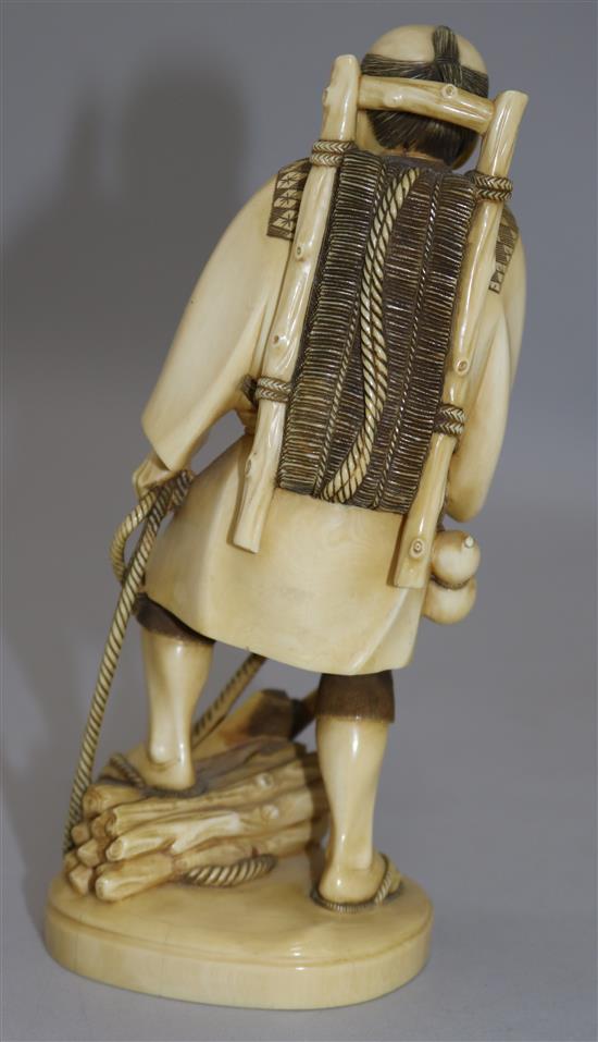 A Japanese ivory figure of a woodsman, early 20th century, 18cm